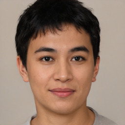 Joyful asian young-adult male with short  brown hair and brown eyes