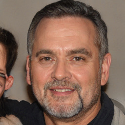 Joyful white middle-aged male with short  brown hair and brown eyes