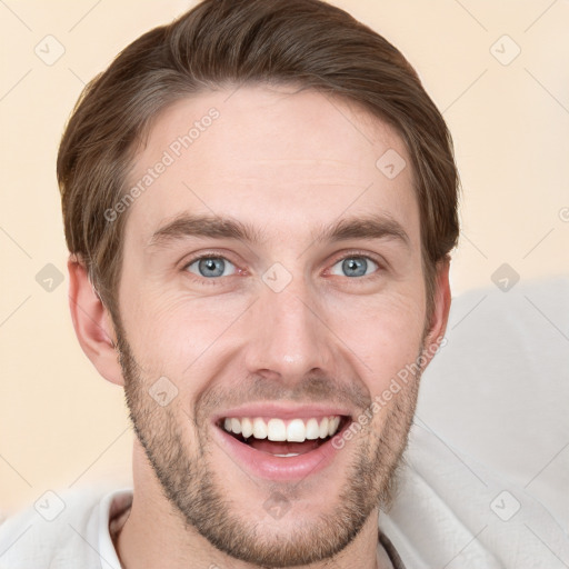 Joyful white young-adult male with short  brown hair and grey eyes