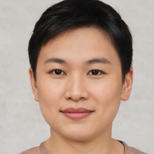 Joyful asian young-adult female with short  black hair and brown eyes