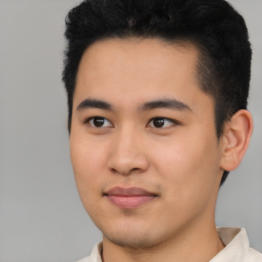 Joyful asian young-adult male with short  black hair and brown eyes