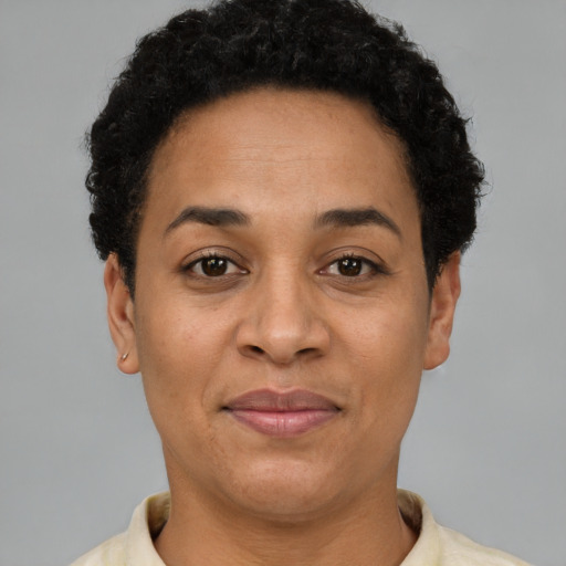 Joyful black adult female with short  brown hair and brown eyes