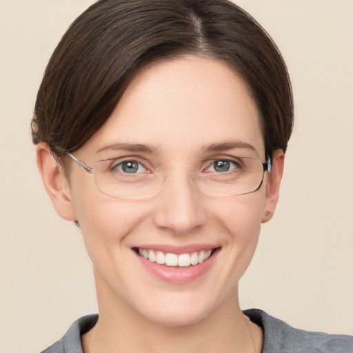 Joyful white young-adult female with short  brown hair and grey eyes