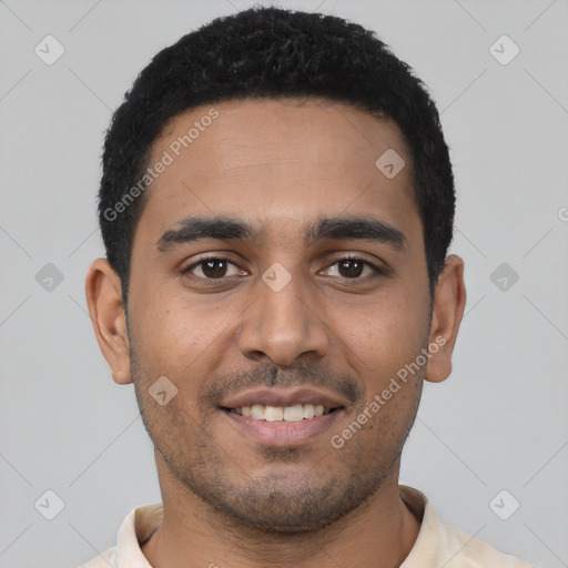 Joyful latino young-adult male with short  black hair and brown eyes