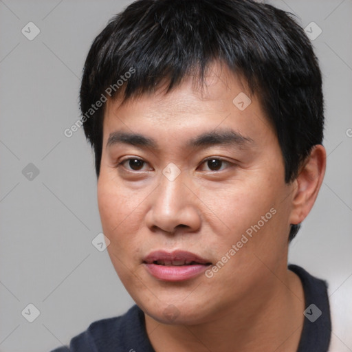 Joyful asian young-adult male with short  black hair and brown eyes