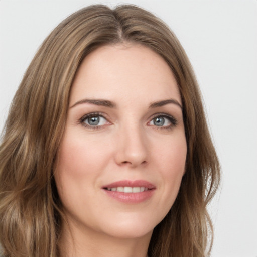 Joyful white young-adult female with long  brown hair and green eyes