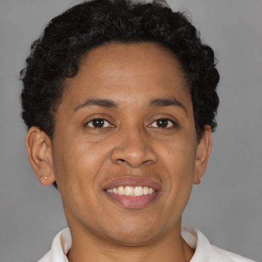Joyful black adult female with short  brown hair and brown eyes
