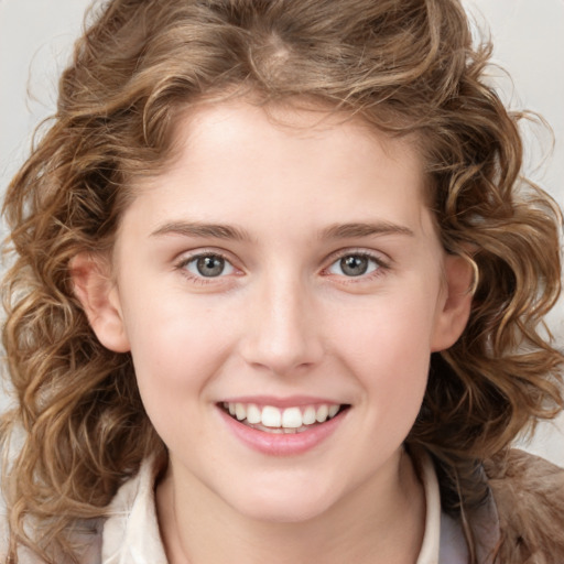 Joyful white child female with medium  brown hair and brown eyes