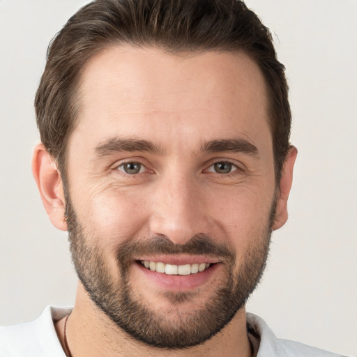 Joyful white young-adult male with short  brown hair and brown eyes