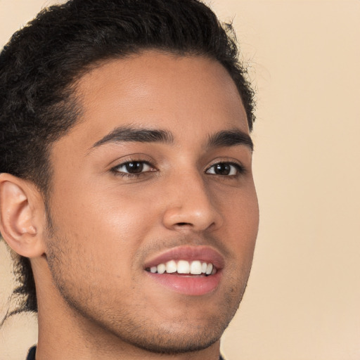 Joyful latino young-adult male with short  brown hair and brown eyes