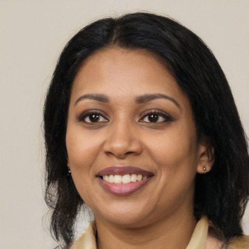 Joyful latino young-adult female with medium  black hair and brown eyes