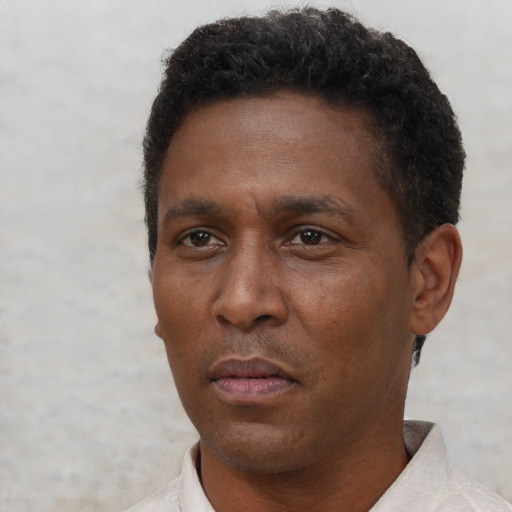 Neutral black adult male with short  brown hair and brown eyes