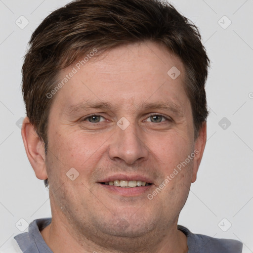 Joyful white adult male with short  brown hair and grey eyes