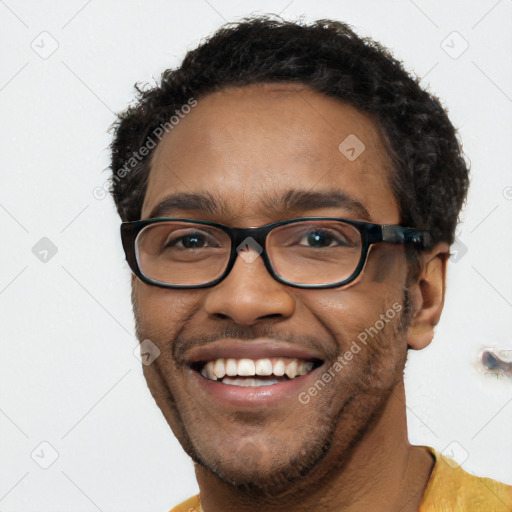 Joyful black young-adult male with short  black hair and brown eyes