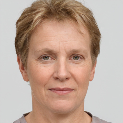 Joyful white middle-aged female with short  brown hair and grey eyes