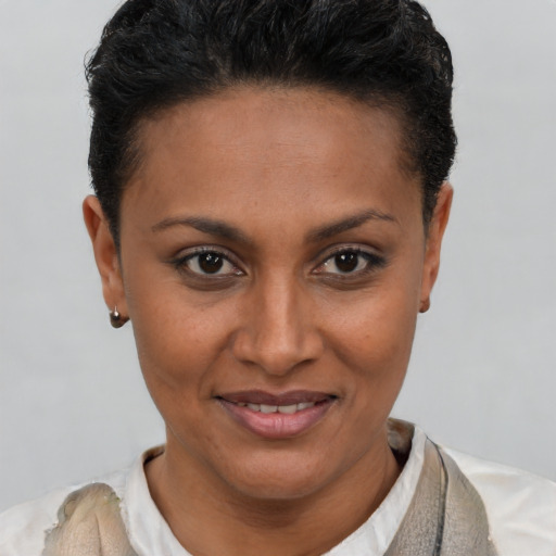 Joyful latino young-adult female with short  brown hair and brown eyes