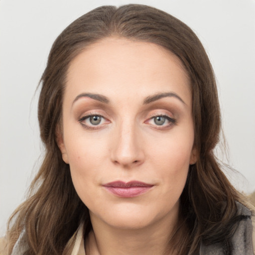 Joyful white young-adult female with long  brown hair and grey eyes