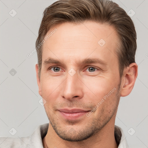 Joyful white young-adult male with short  brown hair and brown eyes