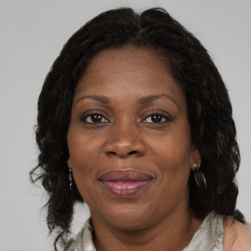 Joyful black adult female with medium  brown hair and brown eyes