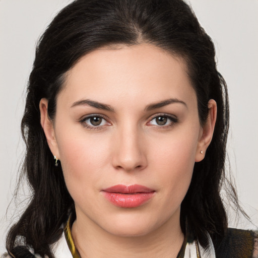 Joyful white young-adult female with long  brown hair and brown eyes