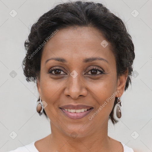 Joyful black adult female with short  brown hair and brown eyes