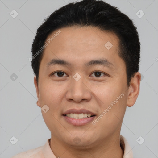 Joyful asian young-adult male with short  black hair and brown eyes