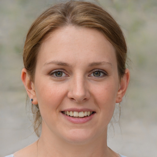 Joyful white young-adult female with medium  brown hair and blue eyes