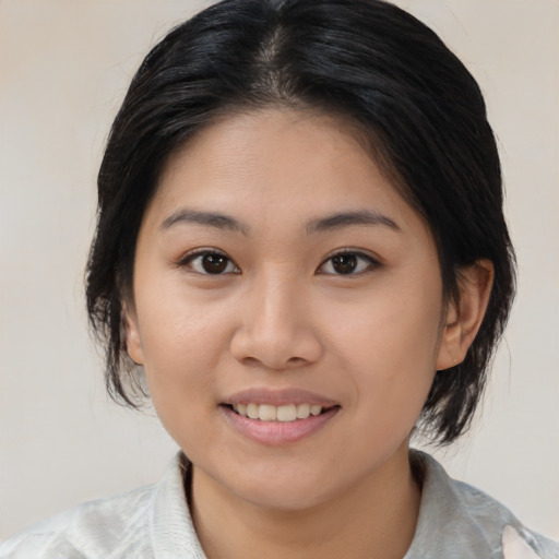 Joyful asian young-adult female with medium  brown hair and brown eyes