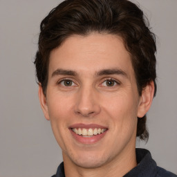 Joyful white young-adult male with medium  brown hair and brown eyes