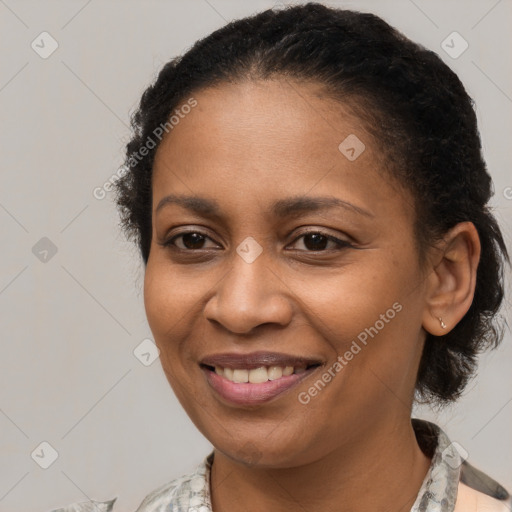 Joyful black young-adult female with medium  brown hair and brown eyes