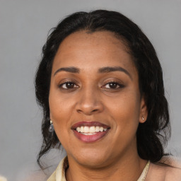 Joyful latino young-adult female with medium  black hair and brown eyes