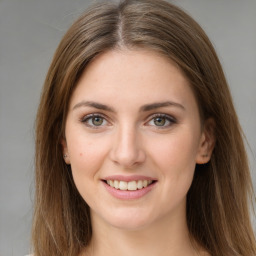 Joyful white young-adult female with long  brown hair and green eyes