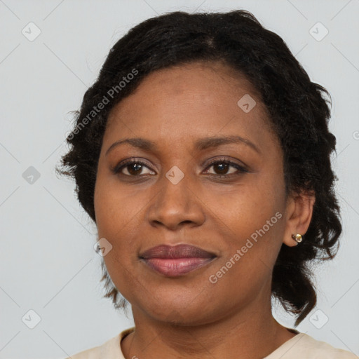 Joyful black adult female with medium  brown hair and brown eyes