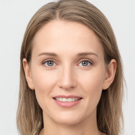 Joyful white young-adult female with long  brown hair and grey eyes