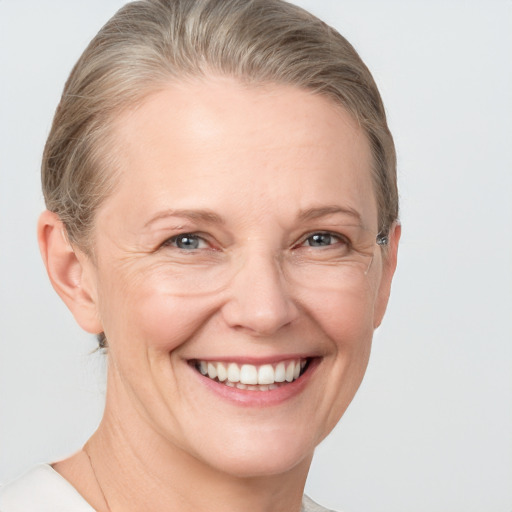 Joyful white adult female with short  brown hair and grey eyes