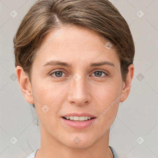 Joyful white young-adult female with short  brown hair and grey eyes