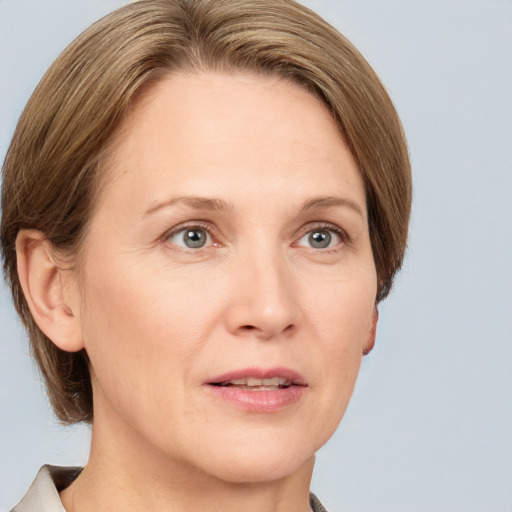 Joyful white adult female with medium  brown hair and grey eyes