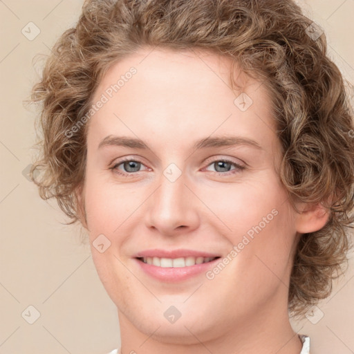 Joyful white young-adult female with medium  brown hair and green eyes