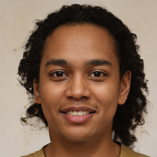 Joyful black young-adult male with short  brown hair and brown eyes