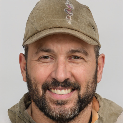 Joyful white adult male with short  brown hair and brown eyes