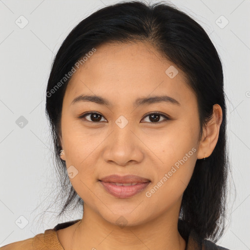 Joyful latino young-adult female with long  brown hair and brown eyes