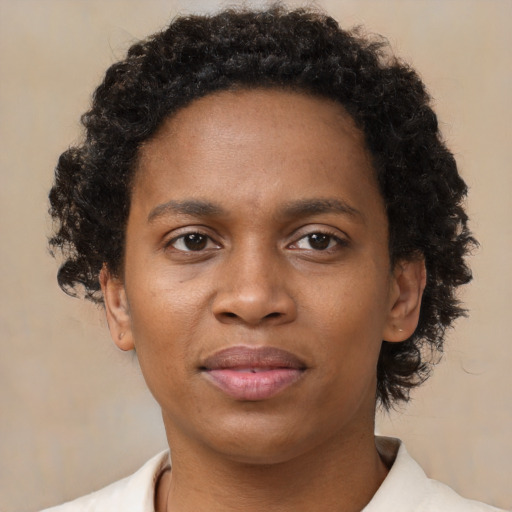 Joyful black adult female with short  brown hair and brown eyes