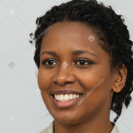 Joyful black young-adult female with long  brown hair and brown eyes