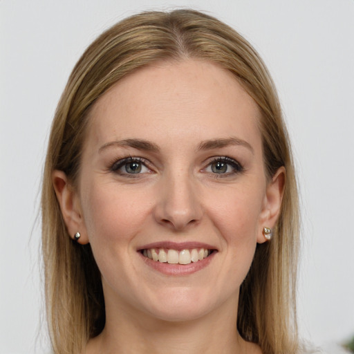 Joyful white young-adult female with long  brown hair and blue eyes