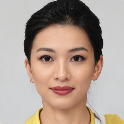 Joyful asian young-adult female with medium  black hair and brown eyes