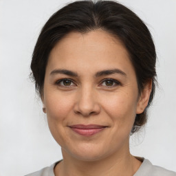 Joyful white adult female with medium  brown hair and brown eyes