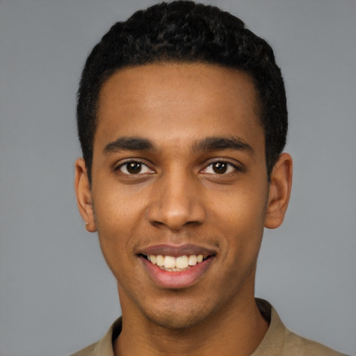 Joyful black young-adult male with short  black hair and brown eyes