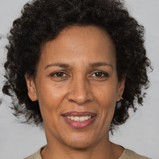 Joyful black adult female with short  brown hair and brown eyes