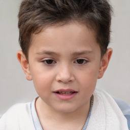 Joyful white child male with short  brown hair and brown eyes