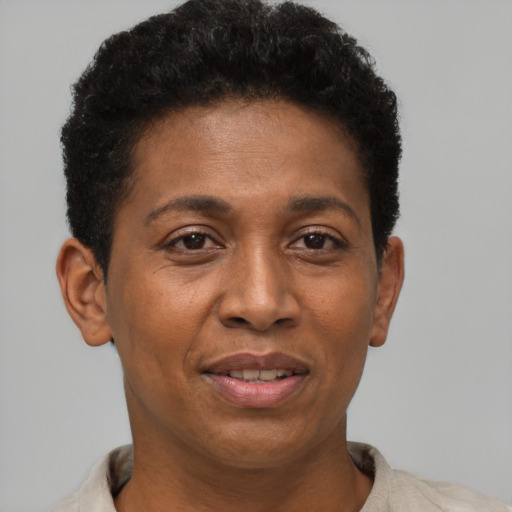 Joyful black adult female with short  brown hair and brown eyes
